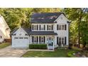 Charming two-story home with black shutters, a covered porch and a manicured front lawn at 535 W Holding Ave, Wake Forest, NC 27587
