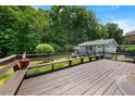 Large wooden deck perfect for entertaining with built-in bench seating and a view of the backyard at 5652 Laurel Crest Dr, Durham, NC 27712