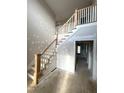 Spacious foyer featuring a staircase with white banisters and natural wood accents, awaiting final touches at 7491 Sweetwater Dr, Nashville, NC 27856