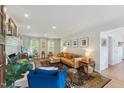 Spacious living room with a beautiful rug, hardwood floors, cozy seating, and lots of natural light at 7804 Tylerton Dr, Raleigh, NC 27613