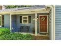 Inviting front porch features a bench, address numbers, and a decorative wreath on the front door at 8513 Applecross Cir, Apex, NC 27539