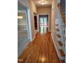 Inviting foyer boasts gleaming hardwood floors and a staircase leading to the upper level at 9009 Miranda Dr, Raleigh, NC 27617