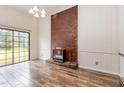 Inviting living room showcasing a brick fireplace and sliding glass doors to the backyard at 1012 Roxboro St, Haw River, NC 27258