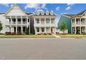Charming two-story home with double porches, red doors, and landscaped front yard at 1211 Gloriosa St, Apex, NC 27523