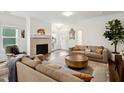 Inviting living room featuring fireplace, hardwood floors, and comfortable seating at 1211 Gloriosa St, Apex, NC 27523