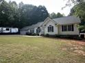 Charming single-Gathering home with lush lawn, garden beds, and a three-car garage at 1312 High Ridge Dr, Mebane, NC 27302