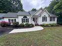 Beautiful single-story home with dark shutters and a well-manicured lawn and garden at 1312 High Ridge Dr, Mebane, NC 27302
