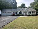 Single story home with attached three-car garage and well-maintained landscaping at 1312 High Ridge Dr, Mebane, NC 27302