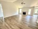 Large living room with wood-look floors and a beautiful fireplace at 138 Sourgum Ct, Zebulon, NC 27597