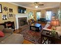 Spacious living room with a brick fireplace, large area rug, and a ceiling fan at 14 Striding Ridge Ct, Durham, NC 27713