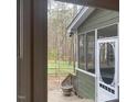 Cozy screened porch with a view of the wooded backyard, offering a serene outdoor living space at 14 Striding Ridge Ct, Durham, NC 27713