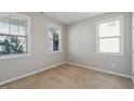 Bright bedroom featuring neutral walls, carpet, and multiple windows for natural light at 1600 Tinos Overlook Way, Apex, NC 27502