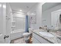 A bathroom featuring a shower and tub combo, white toilet, and granite countertop sink at 165 Bywood Dr, Roxboro, NC 27573