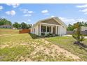 An angle view of a single story home with a manicured lawn and front porch at 165 Bywood Dr, Roxboro, NC 27573