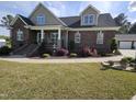 Beautiful brick home with a water feature and attractive landscaping at 1655 Kingfisher Ct, Nashville, NC 27856