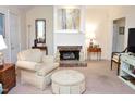 Cozy living room with a brick fireplace, plush seating, and neutral decor at 1707 Falls Church Rd, Raleigh, NC 27609