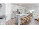 Kitchen with stainless steel appliances, a granite island with stool seating, and an open view to the dining area at 1909 Hinesley Dr, Durham, NC 27703