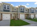 Facade of new townhouses with driveways, front door and attached garages at 1915 Hinesley Dr, Durham, NC 27703