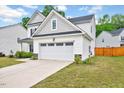 View of the two-car garage with a concrete driveway, showcasing the home's ample parking at 200 Chateau Way, Angier, NC 27501