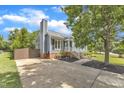 Beautiful home with a chimney, driveway, manicured lawn, and charming front porch with white railings at 2006 Keokuk Ct, Apex, NC 27523