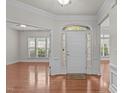 Bright foyer with gleaming hardwood floors, white trim, and views into adjacent rooms at 208 Beckingham Loop, Cary, NC 27519