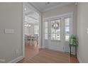 Inviting foyer with hardwood floors and an open view into the formal dining room at 2096 Dowell Ct, Burlington, NC 27215
