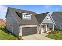 Beautiful home with a well-kept lawn, a two-car garage, and charming front porch with sitting area at 2096 Dowell Ct, Burlington, NC 27215