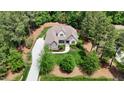 Gorgeous aerial view showcases a home nestled in a beautiful wooded lot at 216 Colonial Ridge Dr, Pittsboro, NC 27312