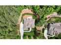 Overhead aerial view shows a home and its backyard nestled in a wooded neighborhood at 216 Colonial Ridge Dr, Pittsboro, NC 27312