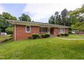 Charming brick home with a manicured lawn, walkway, mature trees and shrubs for great curb appeal at 2315 Oxford Rd, Henderson, NC 27536