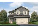 Charming two-story home with gray siding, white trim, and a two-car garage nestled among lush landscaping at 243 New Twin Br Ct, Smithfield, NC 27577
