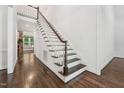 Elegant staircase with dark wood treads and white risers, leading to the upper level at 2709 Penfold Ln, Wake Forest, NC 27587