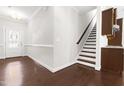 Inviting foyer with hardwood floors and staircase next to dining area at 2727 Masonboro Ferry Dr, Apex, NC 27502