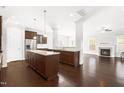 Open concept kitchen with granite countertops, an island, stainless steel appliances, and dark hardwood floors at 2727 Masonboro Ferry Dr, Apex, NC 27502