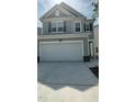 Two-story home featuring a two-car garage, a modern design, and manicured landscaping at 3112 Star Gazing Ln, Durham, NC 27703