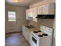 Functional kitchen with appliances, cabinetry, and a door to the backyard at 317 Gary St, Durham, NC 27703