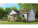 Beautiful home with a covered front porch, lovely landscaping, and verdant yard at 3188 Williams Ln, Graham, NC 27253