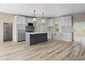 Modern kitchen featuring stainless steel appliances, a center island, and ample cabinet space at 3188 Williams Ln, Graham, NC 27253