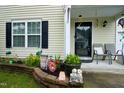 Close up of the decorations and sitting area on the home's front porch at 3848 Griffis Glen Dr, Raleigh, NC 27610