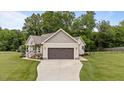 Well-maintained single-Gathering home with a two-car garage, landscaped front yard, and lovely front porch at 422 River Ridge Ln, Timberlake, NC 27583