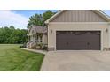 Attached two-car garage with automatic door, convenient access to the house and landscaped yard at 422 River Ridge Ln, Timberlake, NC 27583