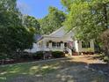 View of the well-maintained single-Gathering home framed by lush greenery and a sidewalk at 50 Peggy Ct, Raleigh, NC 27603