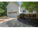 Spacious two-car garage with a concrete driveway and meticulously maintained landscaping at 50 Peggy Ct, Raleigh, NC 27603