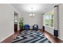 Open concept living room featuring hardwood floors, lots of light and two chairs at 5104 Windmere Chase Dr, Raleigh, NC 27616