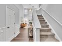 Grand foyer showcasing a staircase leading to a cozy living room with a fireplace at 522 Crossview Ln, Durham, NC 27703