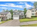 Charming home with gray siding, a driveway, and landscaping at 5412 Robbins Dr, Raleigh, NC 27610