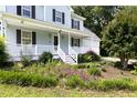 Charming front porch with a white railing and decorative plants, leading to the main entrance at 59 Troy Dr, Fuquay Varina, NC 27526