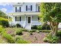 Close-up of a welcoming front porch with beautiful landscaping and a well-maintained garden at 59 Troy Dr, Fuquay Varina, NC 27526