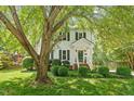 Well-manicured lawn and mature trees frame this lovely home at 669 Tyler Run Dr, Wake Forest, NC 27587