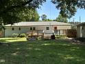 Backyard view featuring a wooden deck and a well-maintained lawn, perfect for outdoor enjoyment at 704 S Mineral Springs Rd, Durham, NC 27703